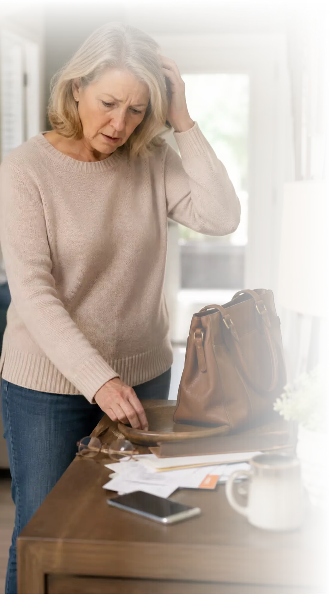 A woman pausing at a table, trying to remember where she put something